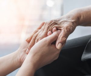Parkinson disease patient, Alzheimer elderly senior, Arthritis person hand in support of nursing family caregiver care for disability awareness day, National care givers month, ageing society concept